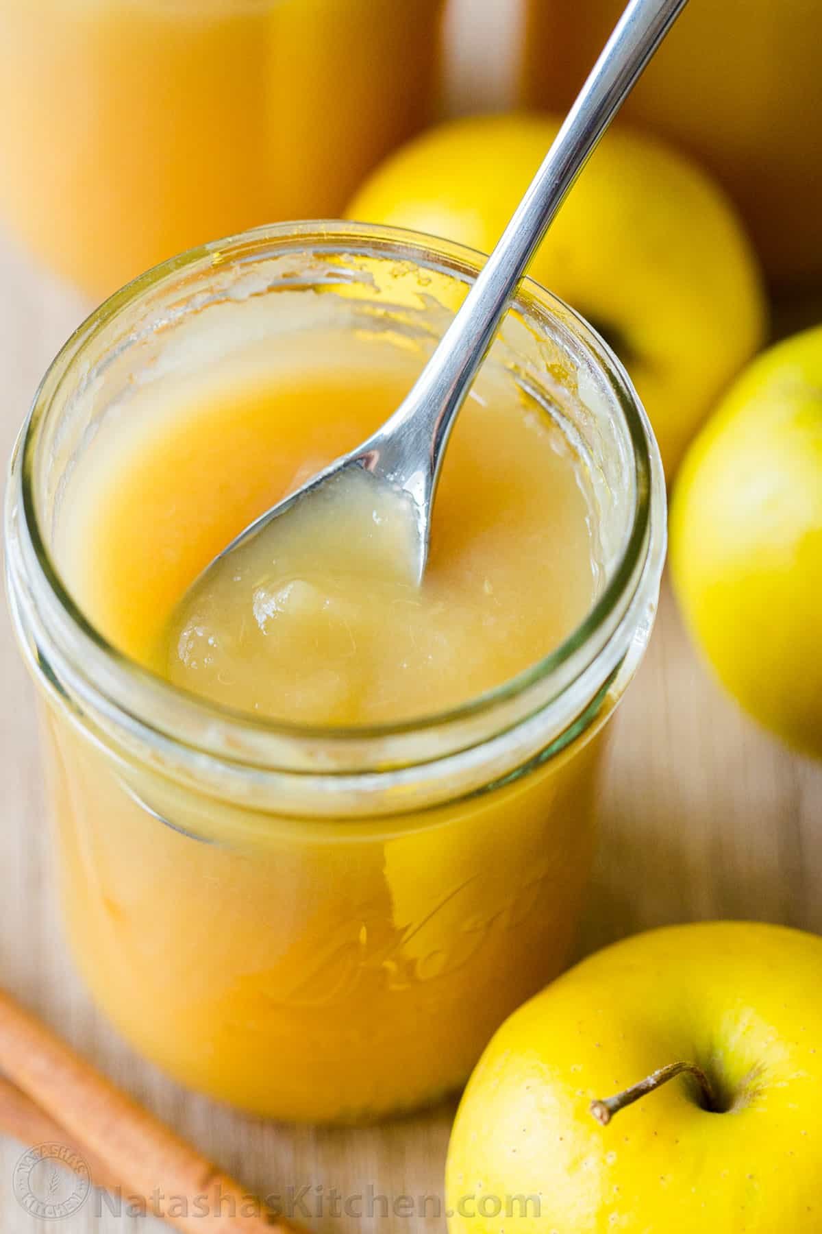 There's nothing like Homemade Applesauce with fresh apple flavor. Use very ripe apples and you don't even need to add sugar. How to make and can applesauce. #applesauce #applesaucerecipe #howtomakeapplesauce #apples #howtocanapplesauce #natashaskitchen #canningrecipes Smooth and Chunky applesauce in jar with spoon