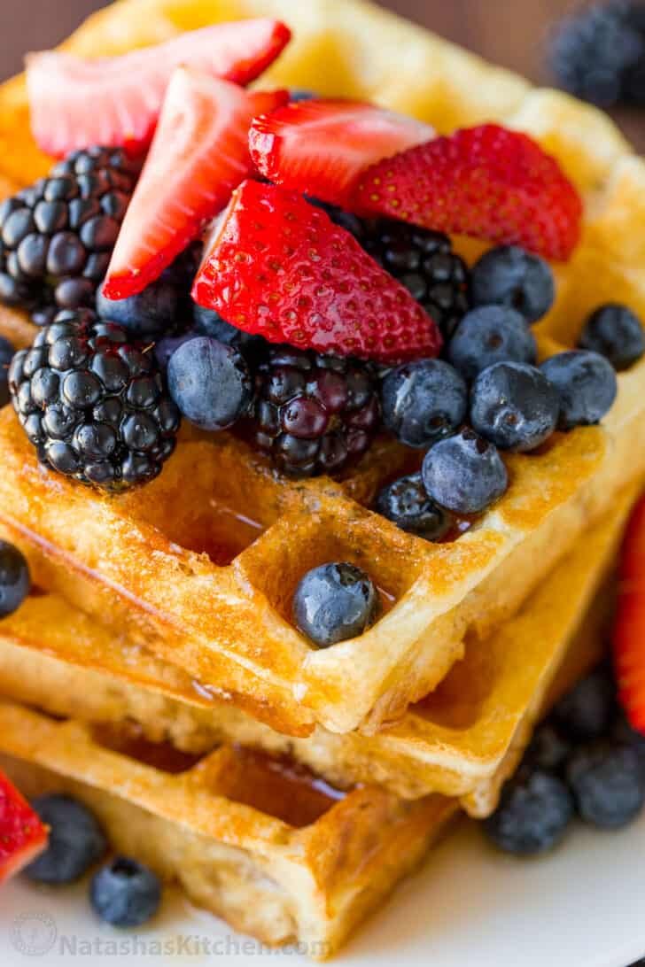 Homemade Waffle Recipe with the secret to super fluffy waffles! Perfect for sweet or savory waffles, and American or Belgian waffle makers. best fluffy waffles stacked on a plate