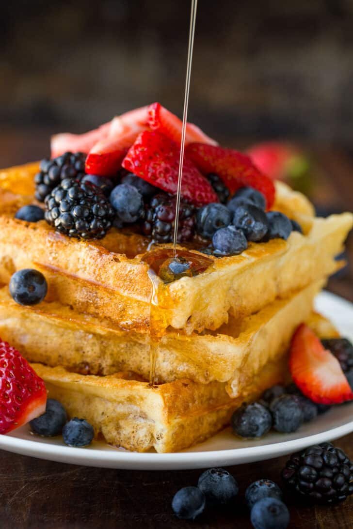 Homemade Waffle Recipe with the secret to super fluffy waffles! Perfect for sweet or savory waffles, and American or Belgian waffle makers. Waffles served with syrup and berries