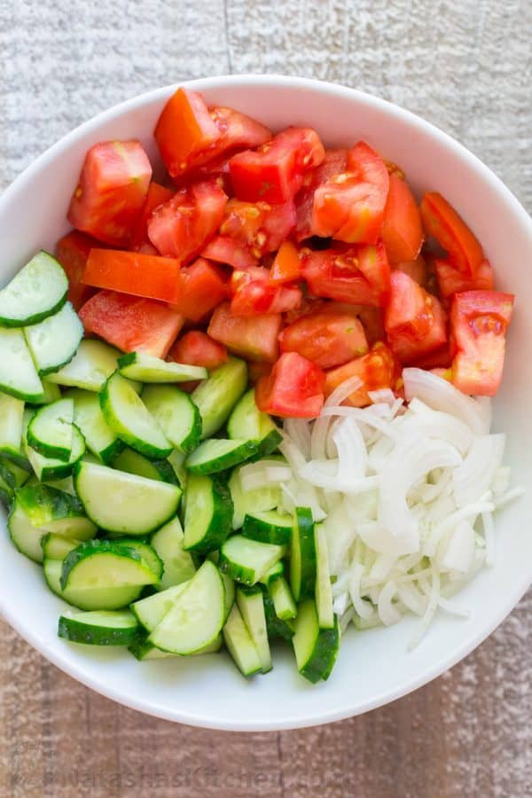 This CLASSIC creamy cucumber and tomato salad is so simple to make and is our go-to summer salad. An easy, excellent cucumber tomato salad. KEEPER! | natashaskitchen.com