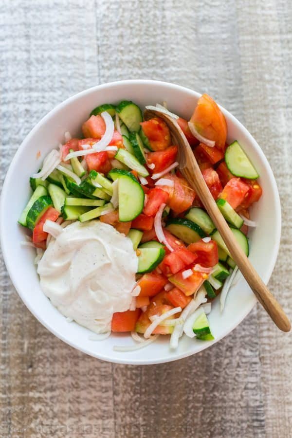 This CLASSIC creamy cucumber and tomato salad is so simple to make and is our go-to summer salad. An easy, excellent cucumber tomato salad. KEEPER! | natashaskitchen.com