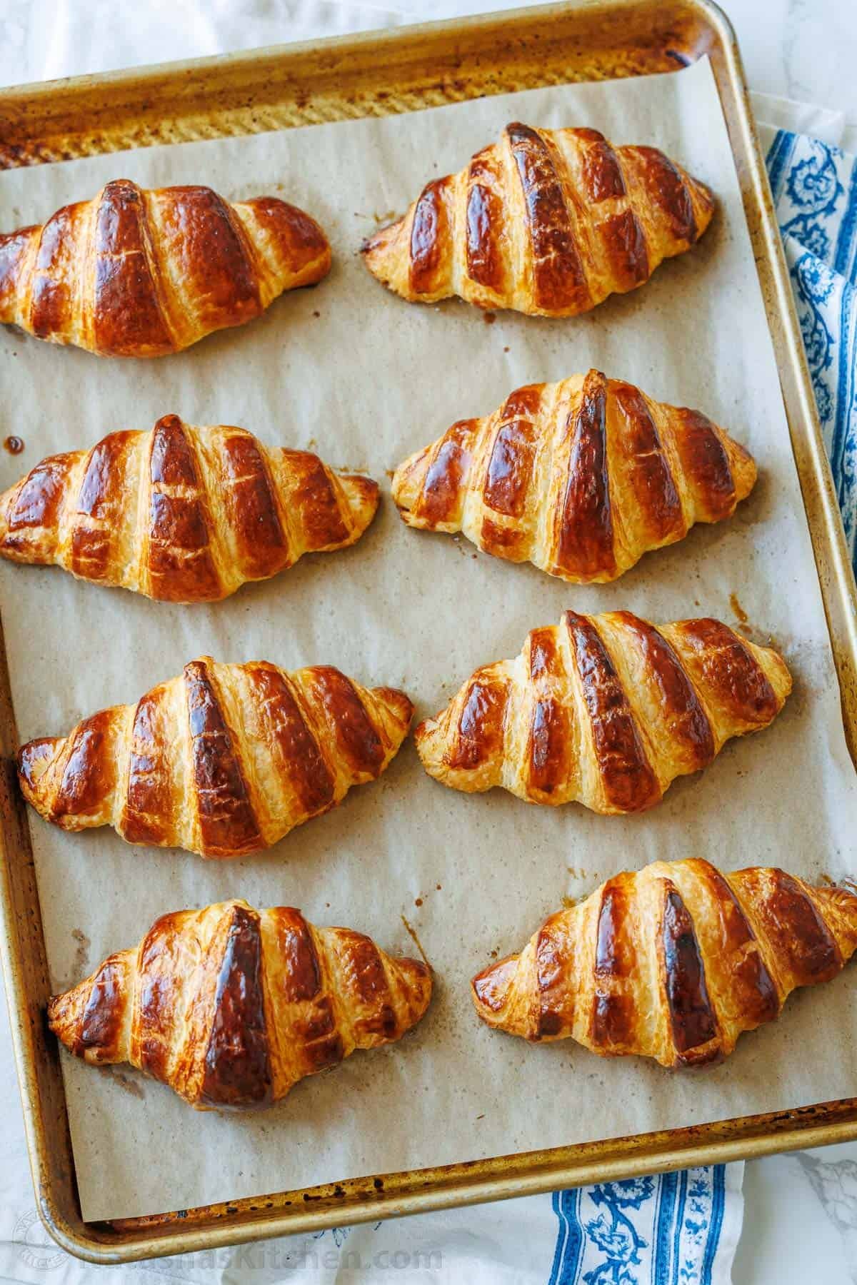Freshly baked French croissant—crispy on the outside and soft on the inside. With tips from Paris, I've perfected this recipe and know you will love it! Baked French croissants on a baking sheet