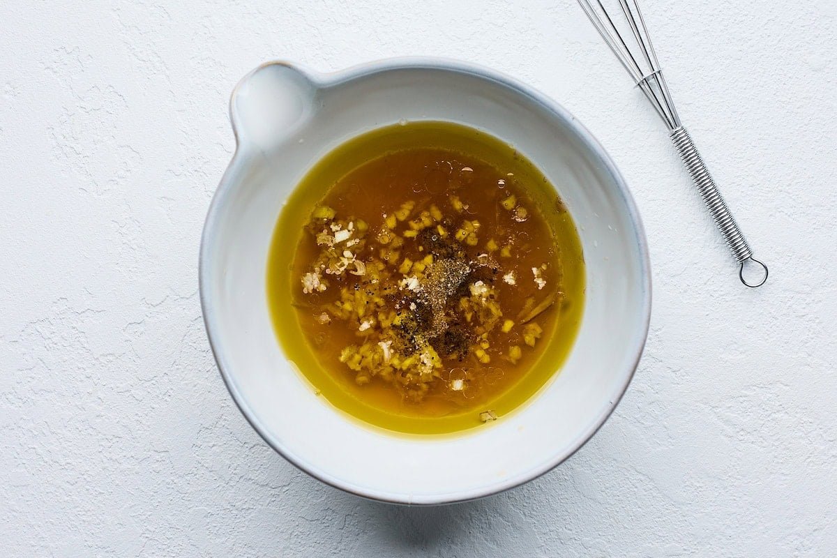 dressing in bowl with small whisk. 