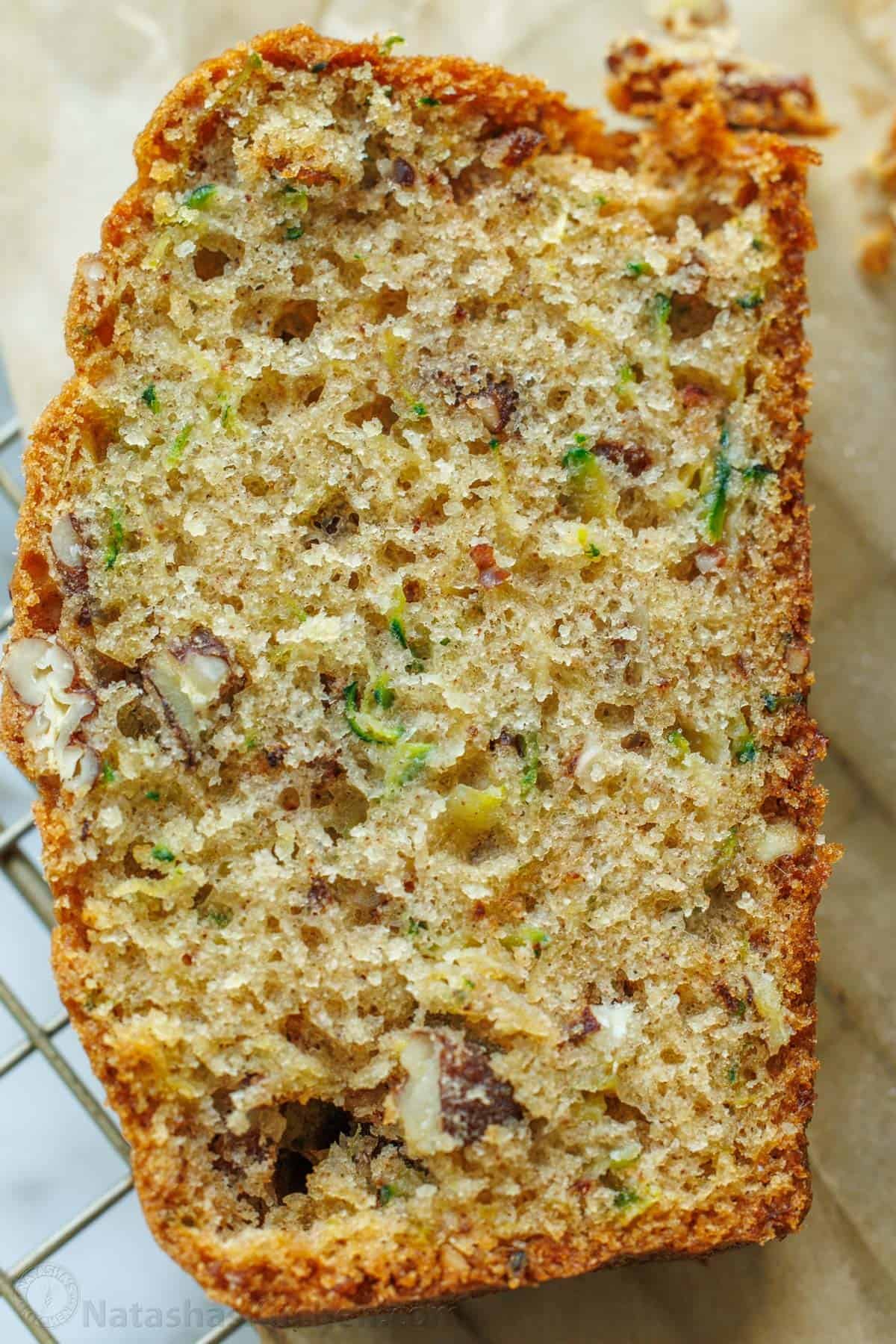 A slice of zucchini bread with nuts and grated zucchini