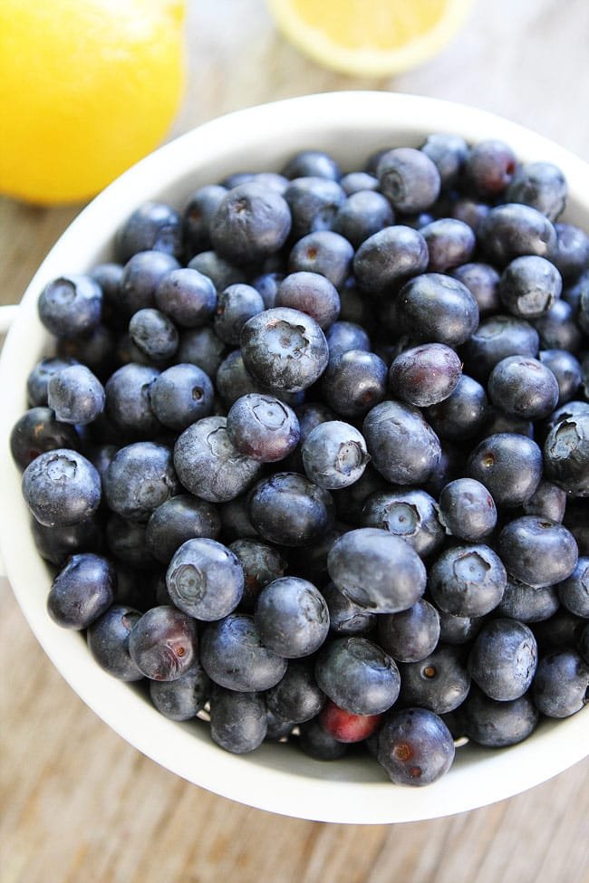 Lemon Blueberry Loaf Cake Recipe on twopeasandtheirpod.com This easy loaf cake makes a great dessert or sweet snack! Bowl Of Blueberries for Blueberry Loaf