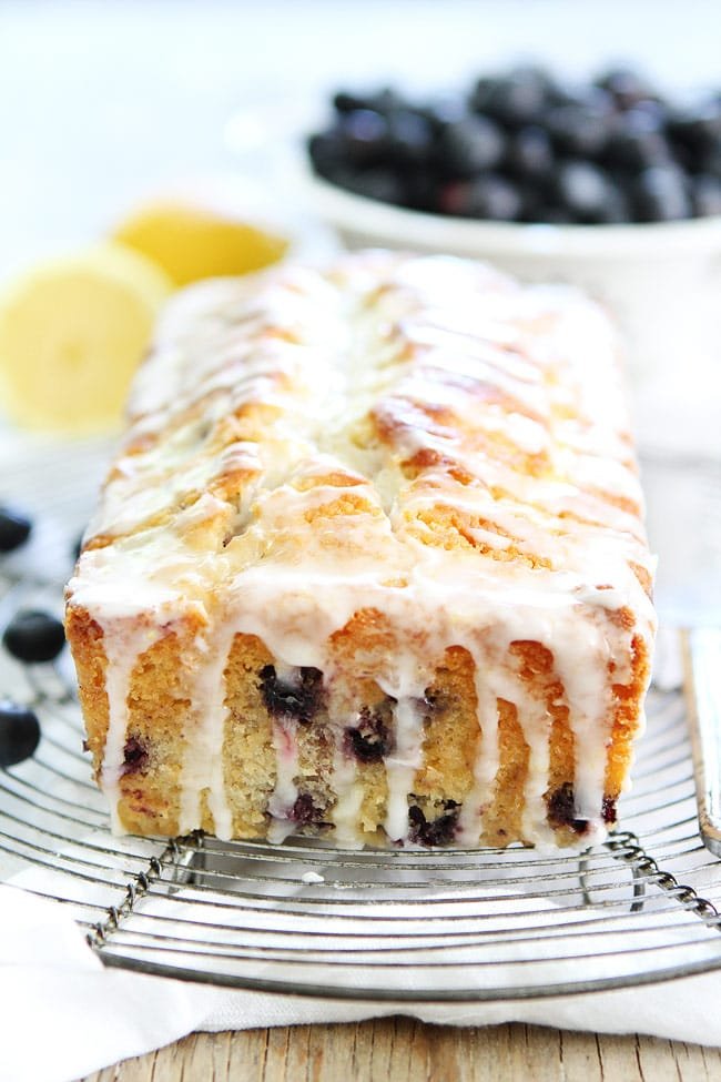 Lemon Blueberry Loaf Cake Recipe on twopeasandtheirpod.com This easy lemon loaf cake is bursting with blueberries! Enjoy a slice for dessert today! Lemon Blueberry Bread Loaf With Frosting