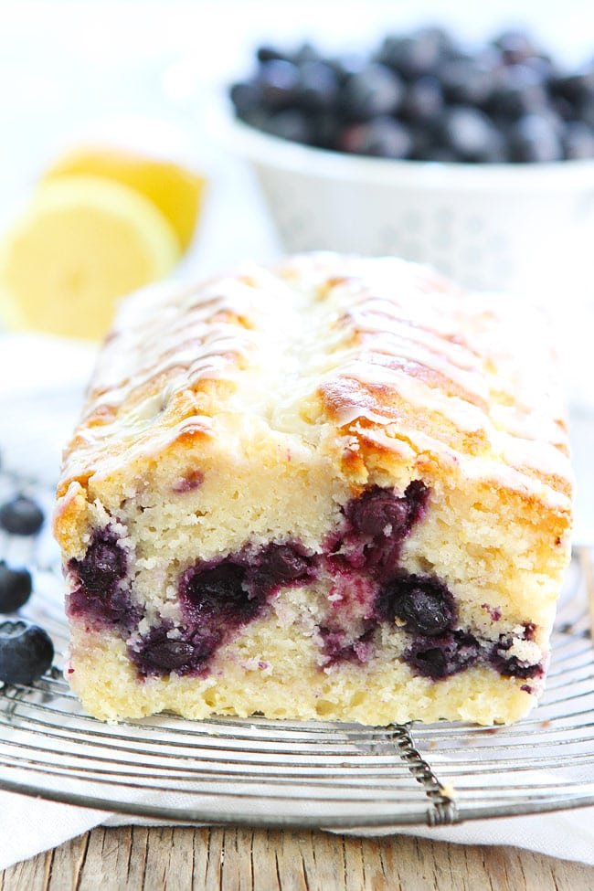 Lemon Blueberry Loaf Cake Recipe on twopeasandtheirpod.com This easy lemon loaf cake is bursting with blueberries! It is the perfect dessert for spring and summer! Lemon Blueberry Pound Cake on Cooling Rack