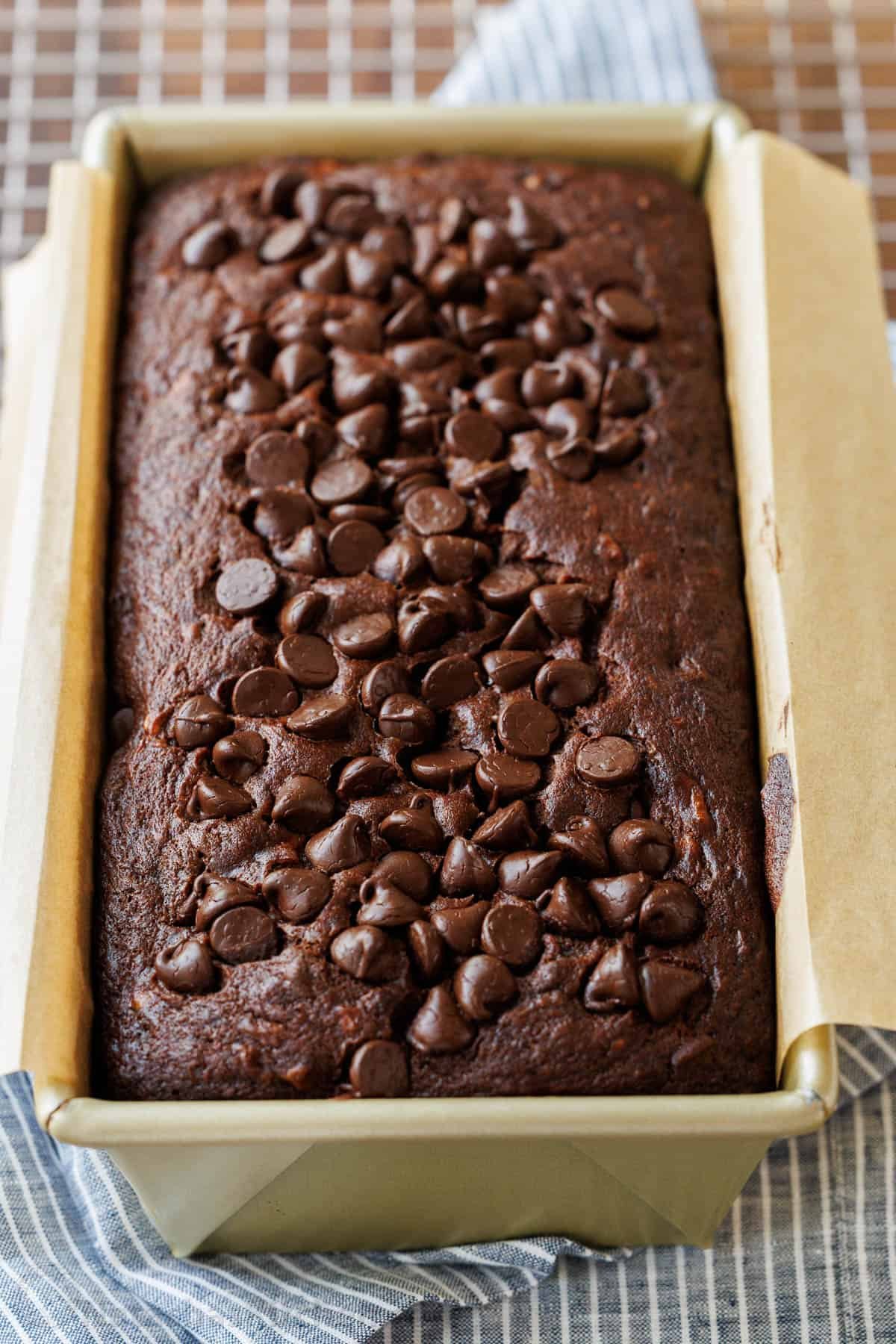 Our Chocolate Banana Bread is easy to make, extra chocolatey (with cocoa and chocolate chips), and stays moist for days. Chocolate Banana Bread fresh out of the oven, resting in the pan on a wire rack