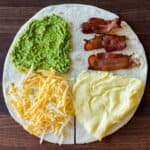 Breakfast tortilla fold with eggs, bacon, avocado and cheese