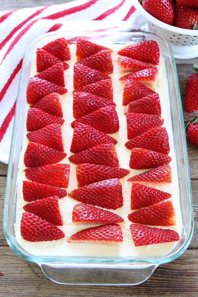 Strawberries and Cream Bars Recipe on twopeasandtheirpod.com Sugar cookie bars topped with white chocolate cream cheese frosting and strawberries. These bars are amazing! Strawberries and Cream Bars Recipe