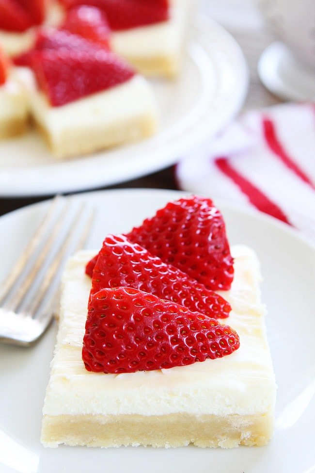 Strawberries and Cream Bars Recipe on twopeasandtheirpod.com Sugar cookie bars topped with white chocolate cream cheese frosting and strawberries. These bars are dreamy! Strawberries and Cream Bars Recipe