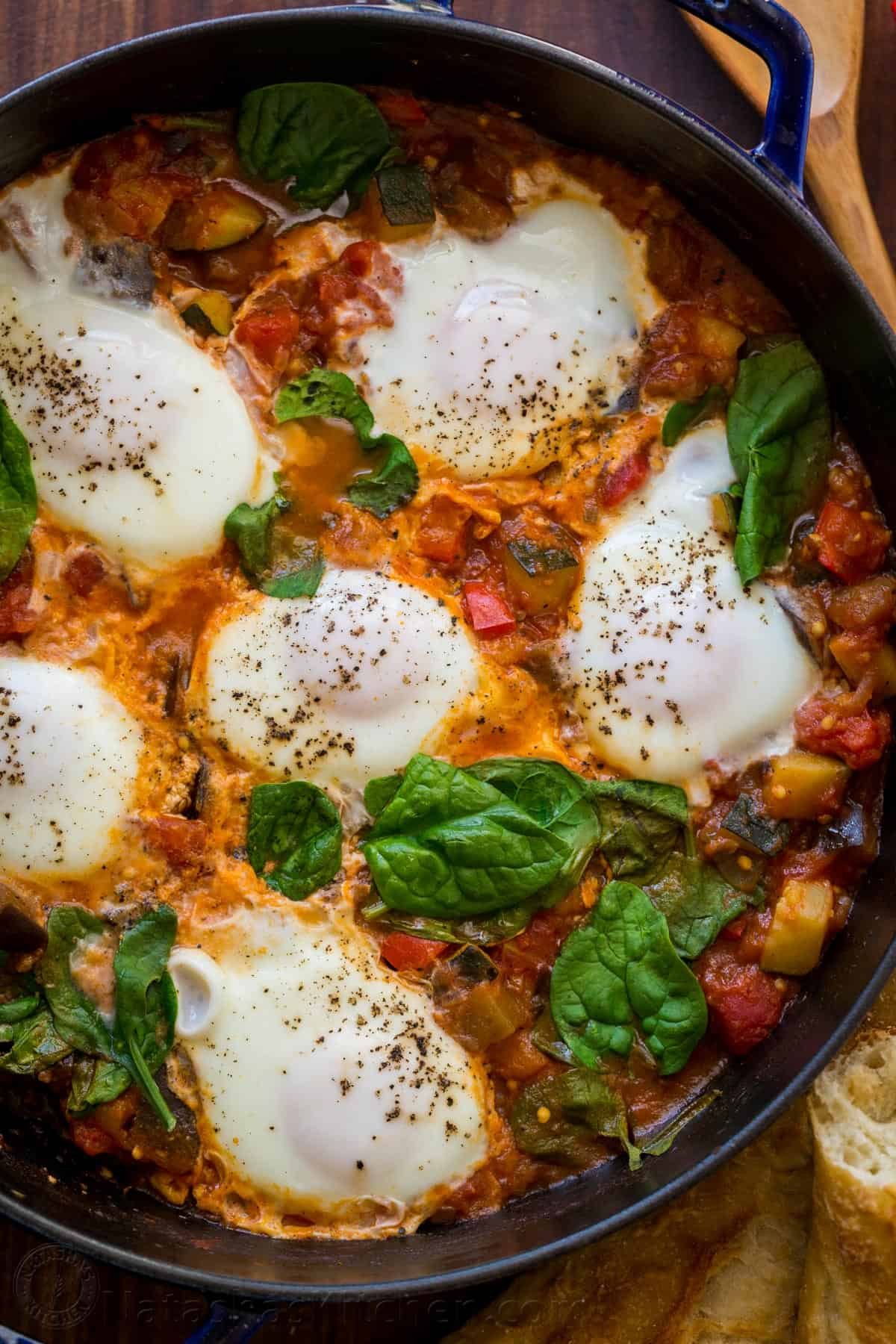This Eggplant Shakshuka is loaded with zucchini and eggplant in a spicy tomato-based sauce, crowned with egg and fresh spinach. Spicy Shakshuka with eggplant and zucchini