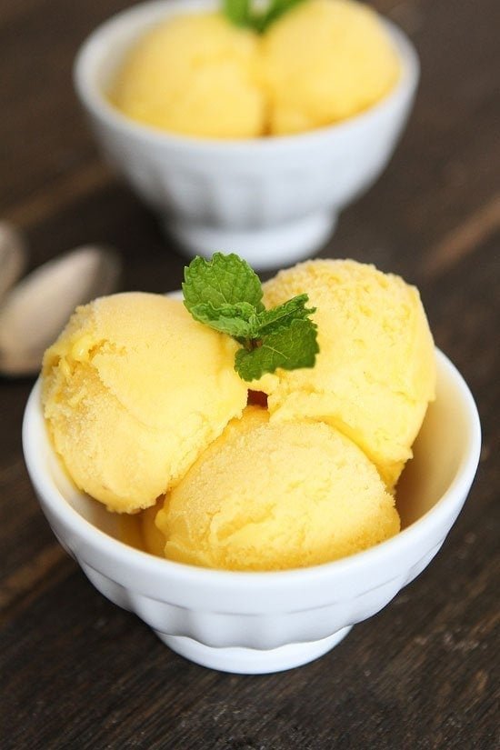Pineapple Mango Sorbet Recipe on twopeasandtheirpod.com This easy sorbet recipe is creamy, sweet, and so refreshing. It is the perfect summer dessert! Pineapple Mango Sorbet Recipe