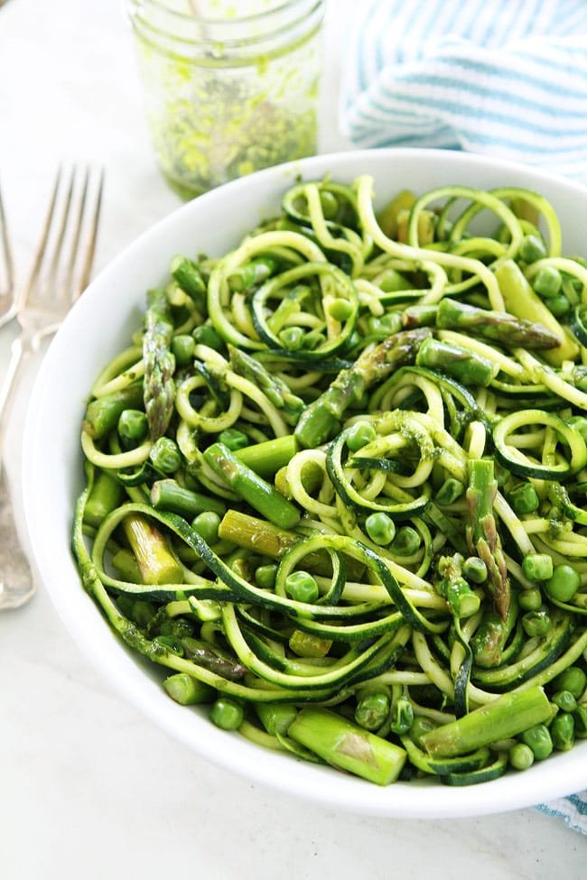 Zucchini Noodles with Asparagus, Peas, and Basil Vinaigrette Recipe on twopeasandtheirpod.com This vibrant green zucchini noodle dish is perfect for spring. It is light, refreshing, and super simple to make. Zucchini Noodles with Asparagus, Peas, and Basil Vinaigrette Recipe