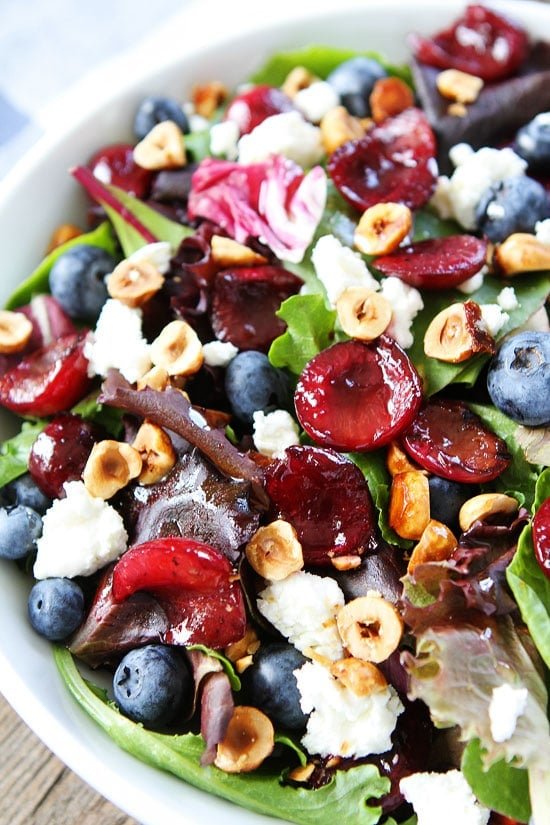 Balsamic Grilled Cherry, Blueberry, Goat Cheese, and Candied Hazelnut Salad Recipe on twopeasandtheirpod.com Perfect for all of your summer BBQ's, potlucks, and picnics! Balsamic Grilled Cherry, Blueberry, Goat Cheese, and Candied Hazelnut Salad Recipe