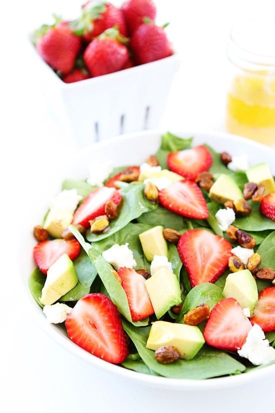 Strawberry Spinach Salad with Avocado, Goat Cheese, and Candied Pistachios Recipe on twopeasandtheirpod.com I love everything about this salad! Strawberry Spinach Salad Recipe