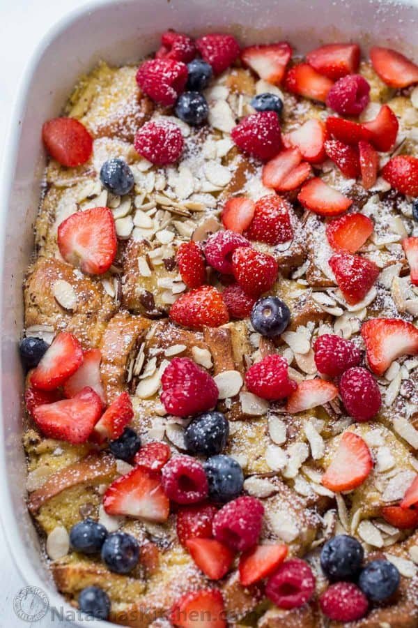 French Toast Casserole bread with almonds and berries in a baking dish. 