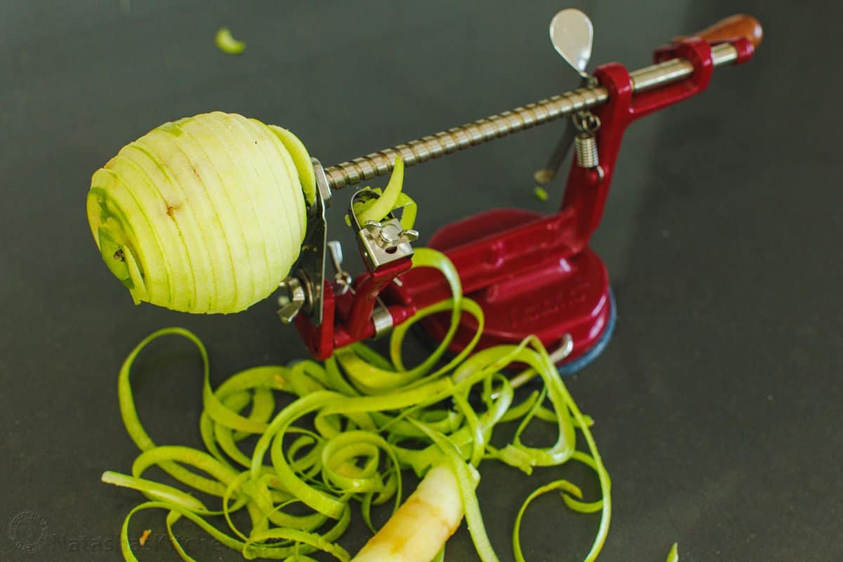 Apple peeler with an apple A picture of a Granny Smith being peeled on my favorite peeler