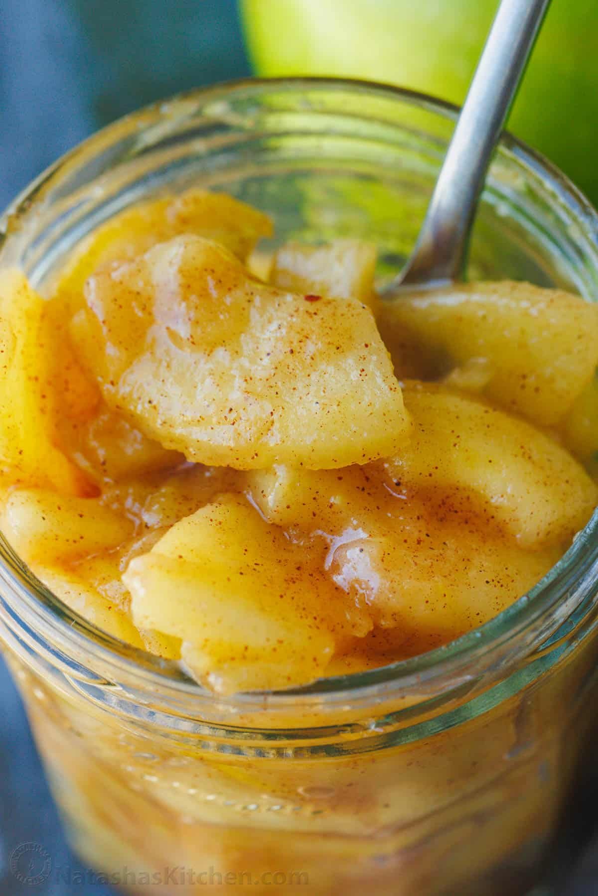 Sauteed Cinnamon Apples taste just like the filling in a cozy apple pie. Sauteed Apples are the perfect topping for breakfast or dessert. Sautéed cinnamon apples in a mason jar with serving spoon