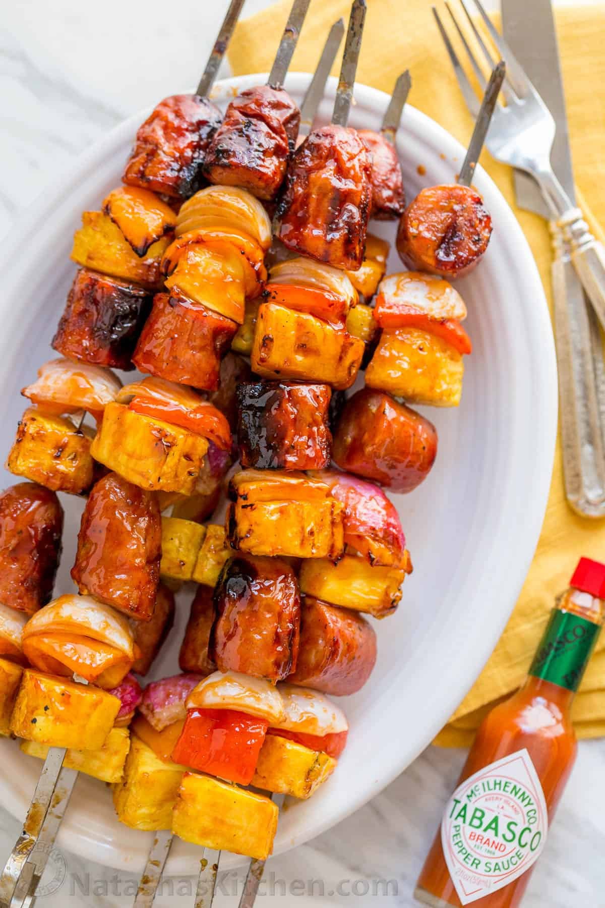 Grilled pineapple sausage Kabobs are sweet, spicy, smoky, and tasty! You'll love the easy glaze on these pineapple sausage kabobs. Grilled pineapple sausage skewers that are sweet, spicy, smoky and so flavorful! You won’t believe the easy glaze. Easy, excellent brunch skewers recipe. | natashaskitchen.com