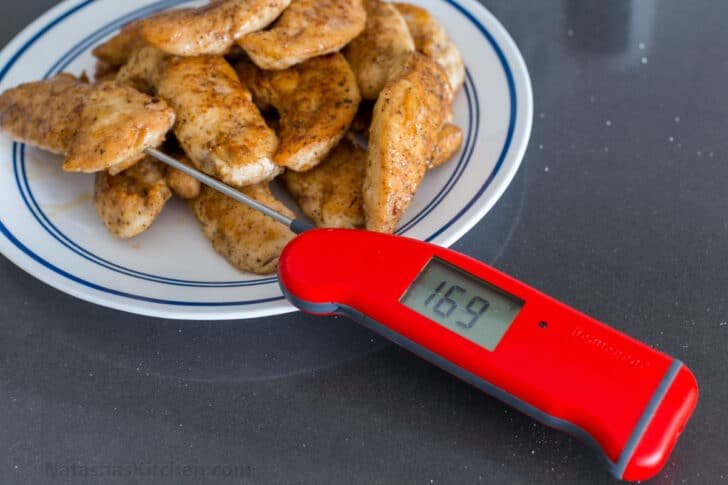 Instant read thermometer checking chicken for doneness