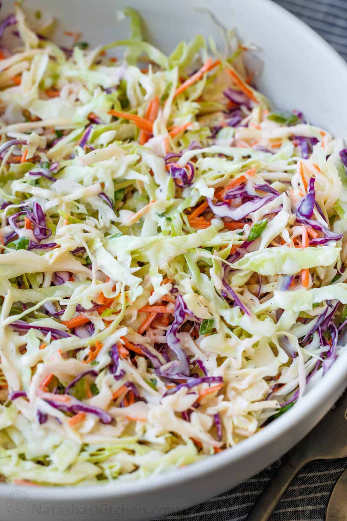 How to shred cabbage and carrots for homemade coleslaw. coleslaw served in a white bowl