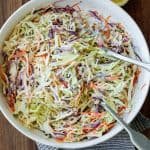Coleslaw in a mixing bowl with creamy dressing