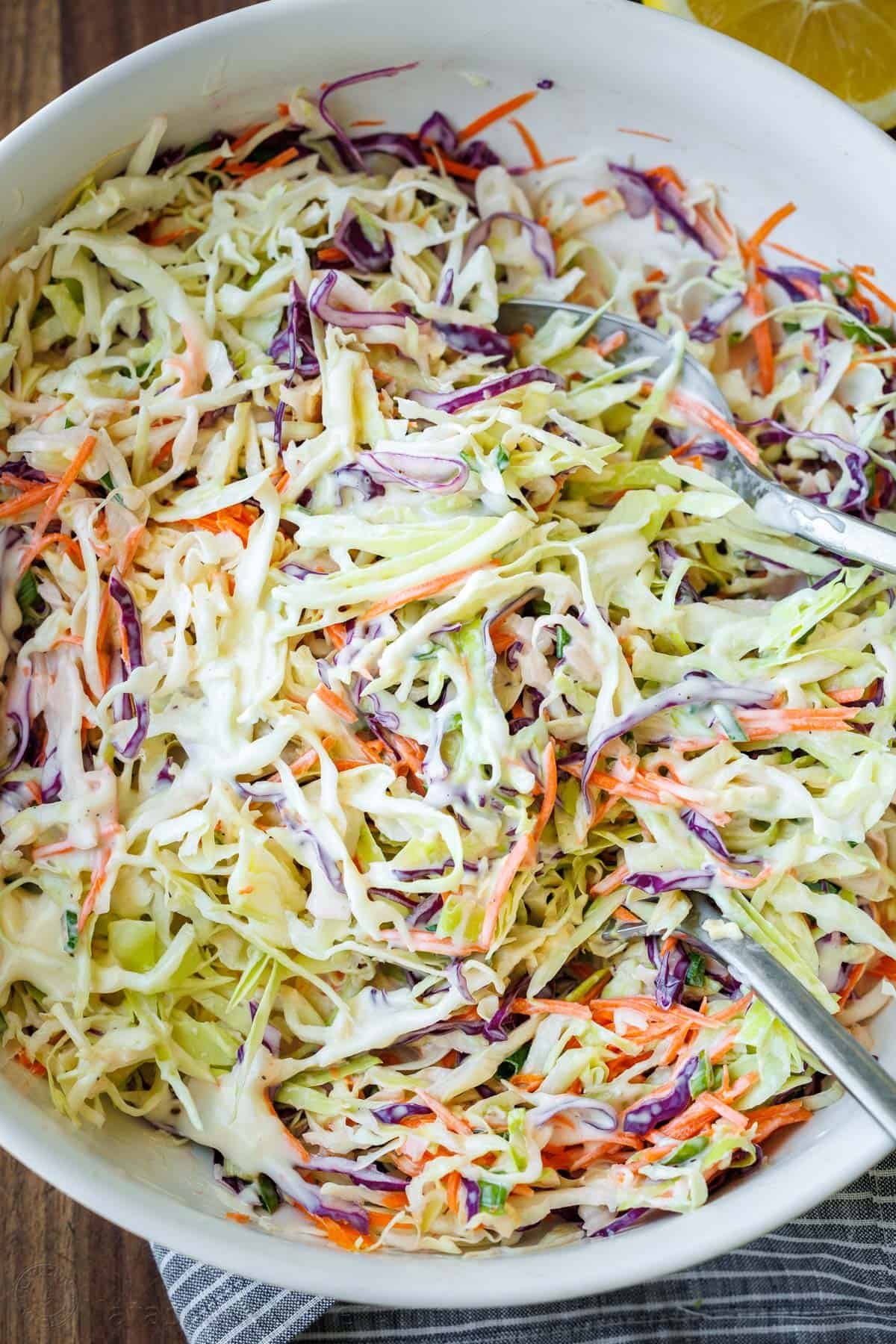 Classic Coleslaw with the best homemade coleslaw dressing. This creamy coleslaw is ready in 10 minutes and perfect for sandwiches, potlucks and cookouts. #coleslaw #coleslawrecipe #salad #sidedish #grillingside #homemadecoleslaw #coleslawdressing #natashaskitchen