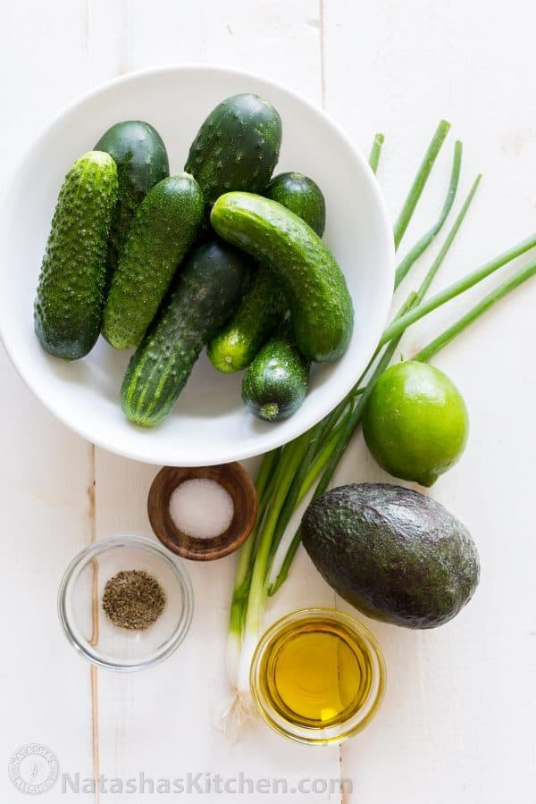 Ingredients for cucumber salad with avocado, green onion, lime juice