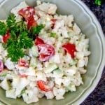 A bowl do cauliflower, cucumber and tomato salad
