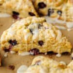 Blueberry scone cut into wedges with lemon glaze drizzled on top