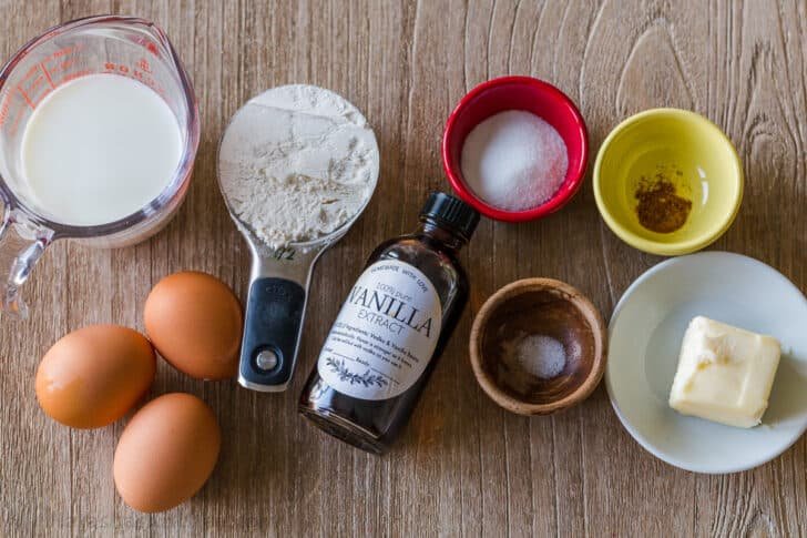 Ingredients for dutch baby pancakes with eggs, flour, milk, butter, sugar, nutmeg, salt