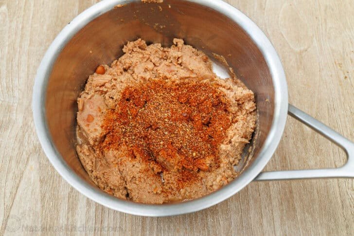 Add homemade taco seasoning to refried beans for 7-Layer Dip