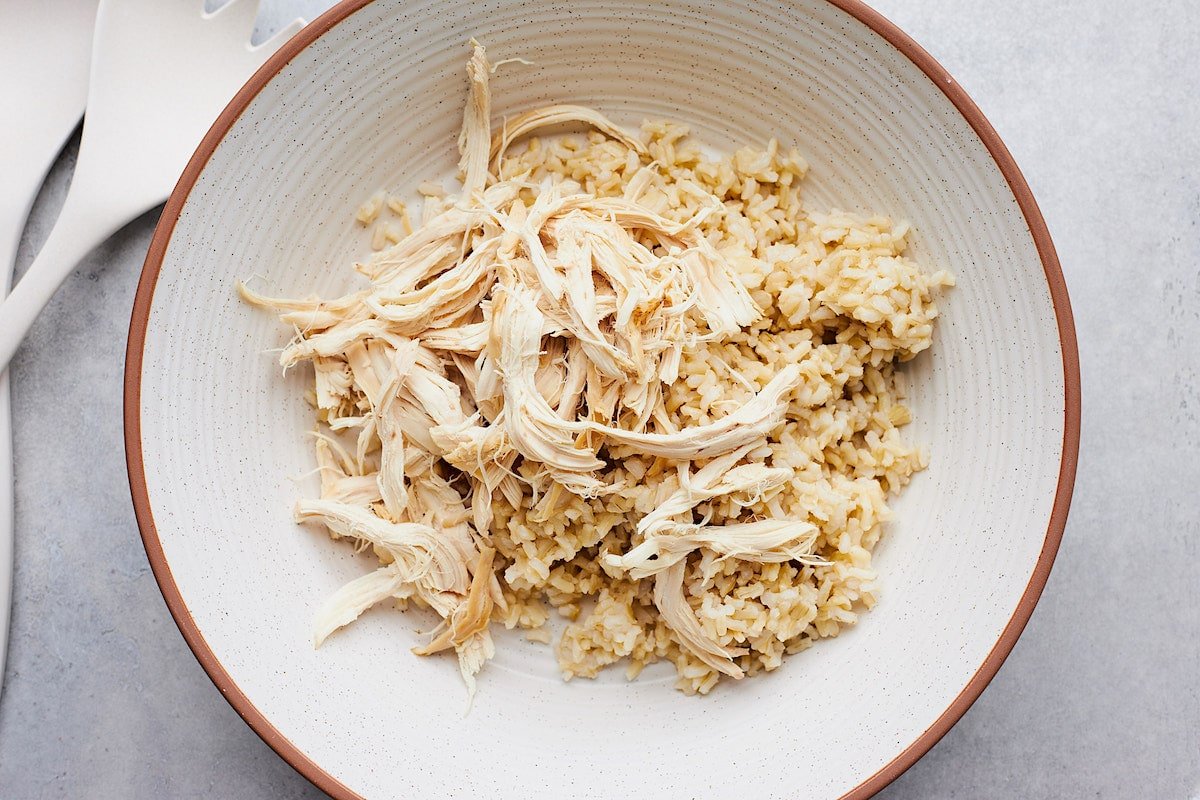 brown rice and shredded chicken in large bowl. 