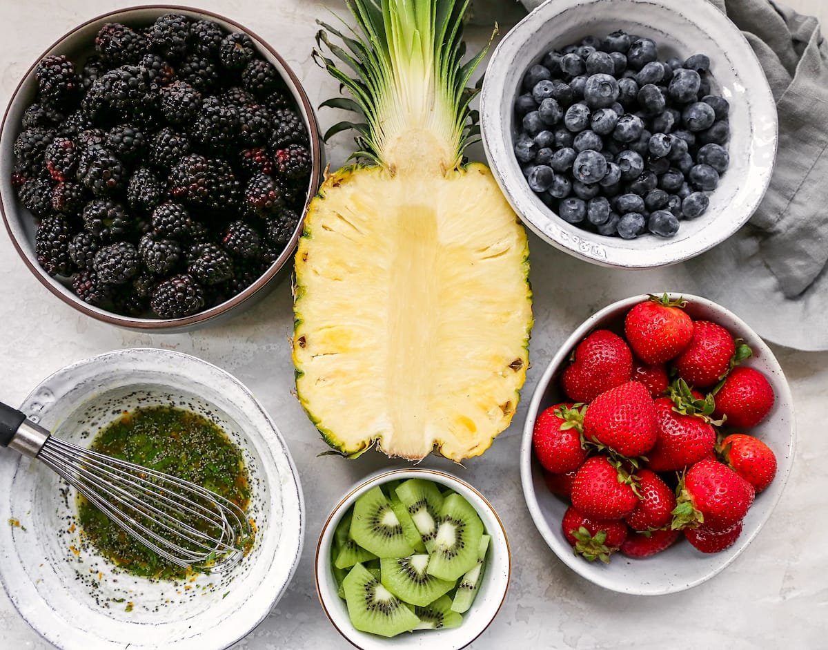 Fruit salad ingredients in bowls.