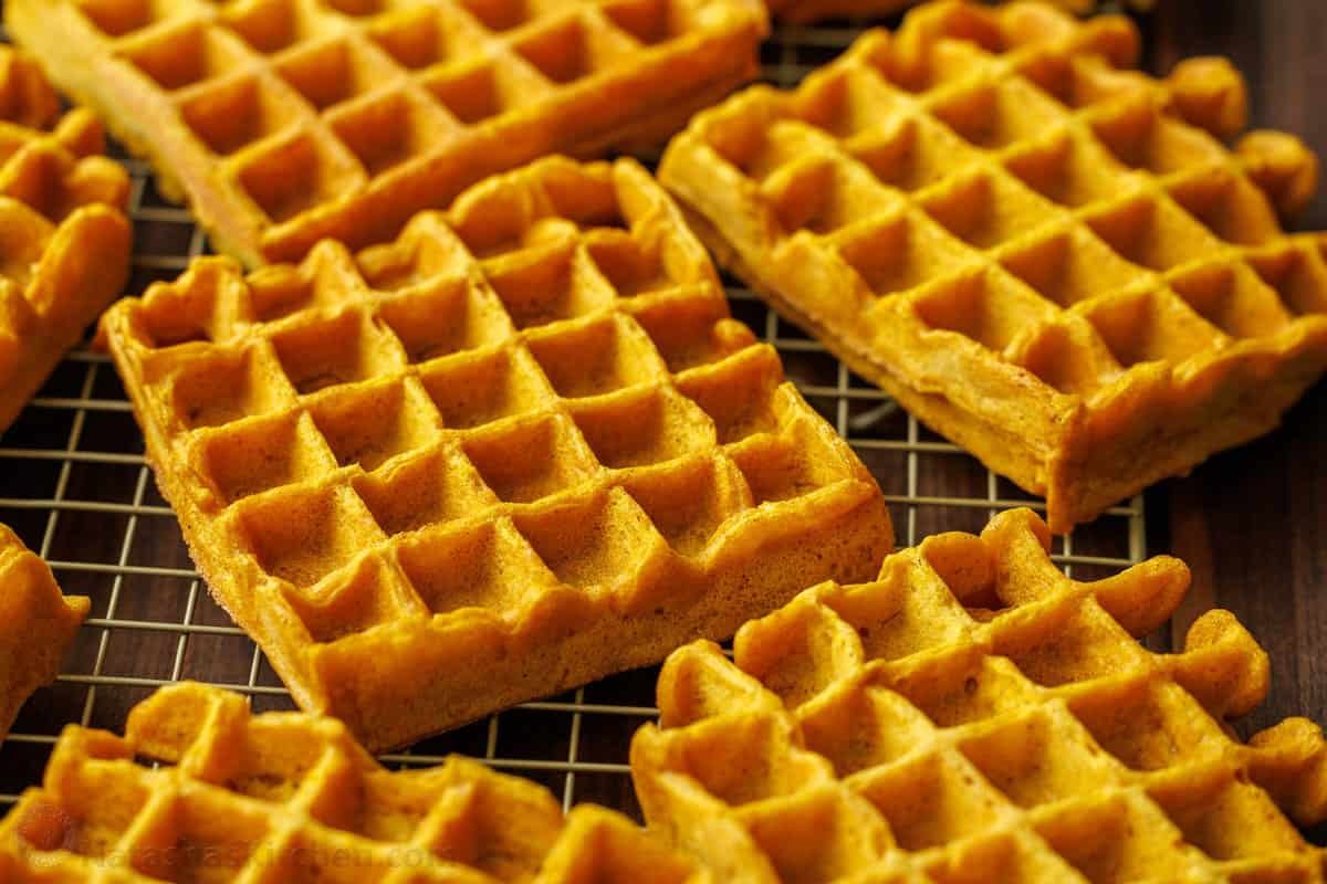 Pumpkin spice waffles arranged on a wire rack