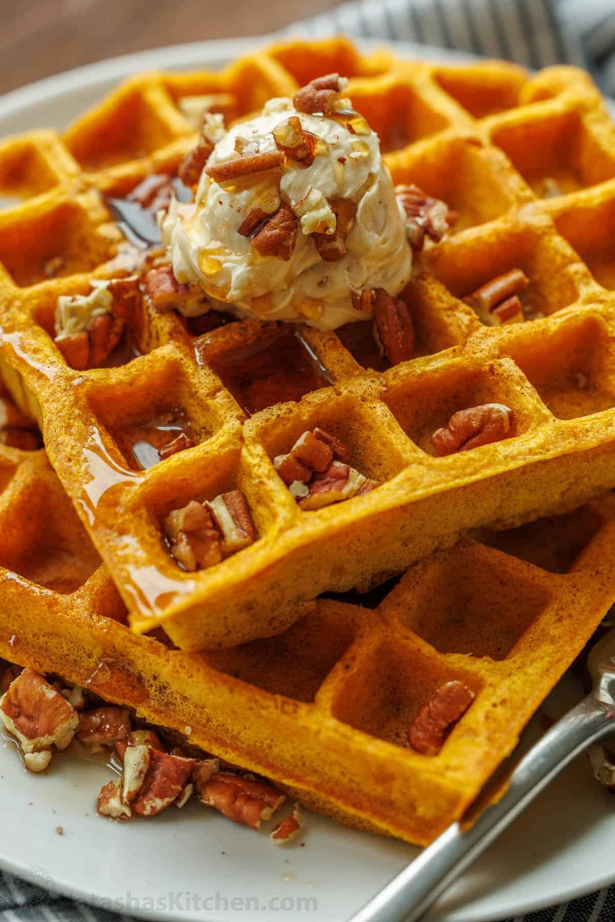 Pumpkin waffles served with whipped honey butter, toasted pecans, and maple syrup