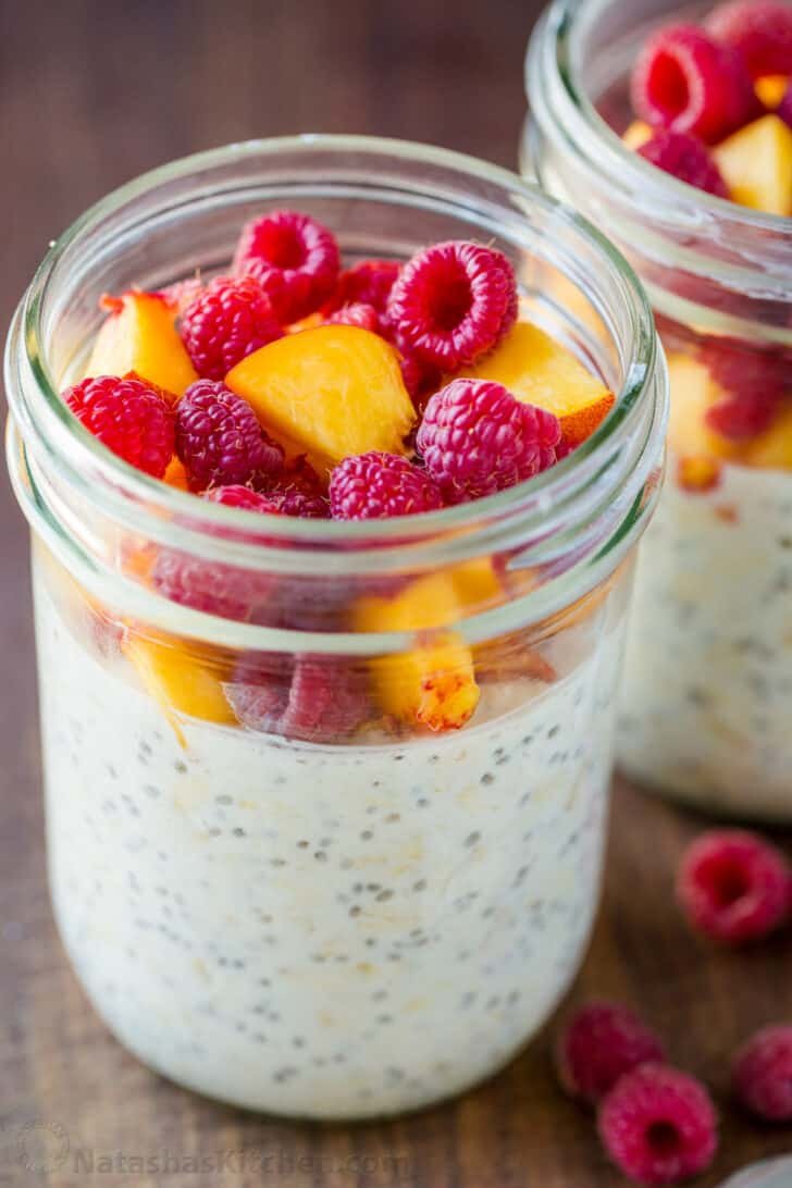 Easy and creamy Overnight Oats is the best make-ahead breakfast. No cooking required! Just stir, refrigerate and add your favorite toppings. Up close jar of overnight oats with raspberries and nectarines