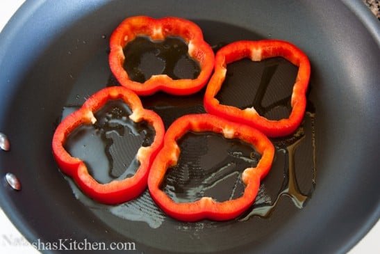 Four bell pepper rings on an oiled skillet 