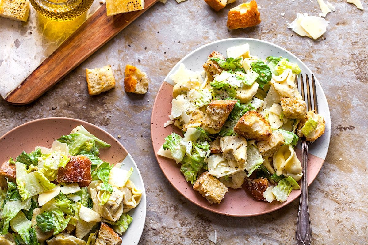 Tortellini Caesar Salad on plates with fork.