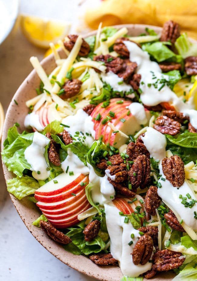 Apple Pecan Salad with white cheddar, candied pecans, chives, and creamy lemon dressing.