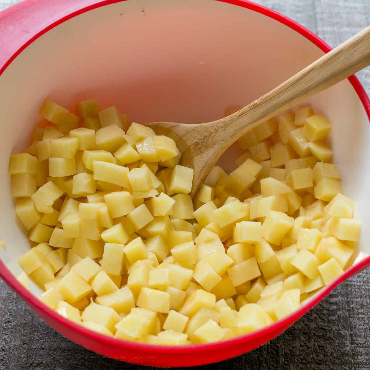 Our go-to, easy breakfast potatoes recipe uses simple ingredients and the best cooking method for potatoes, so each bite is delicious! potato cubes in a mixing bowl