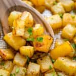 Breakfast potatoes in cubes on a wooden spoon