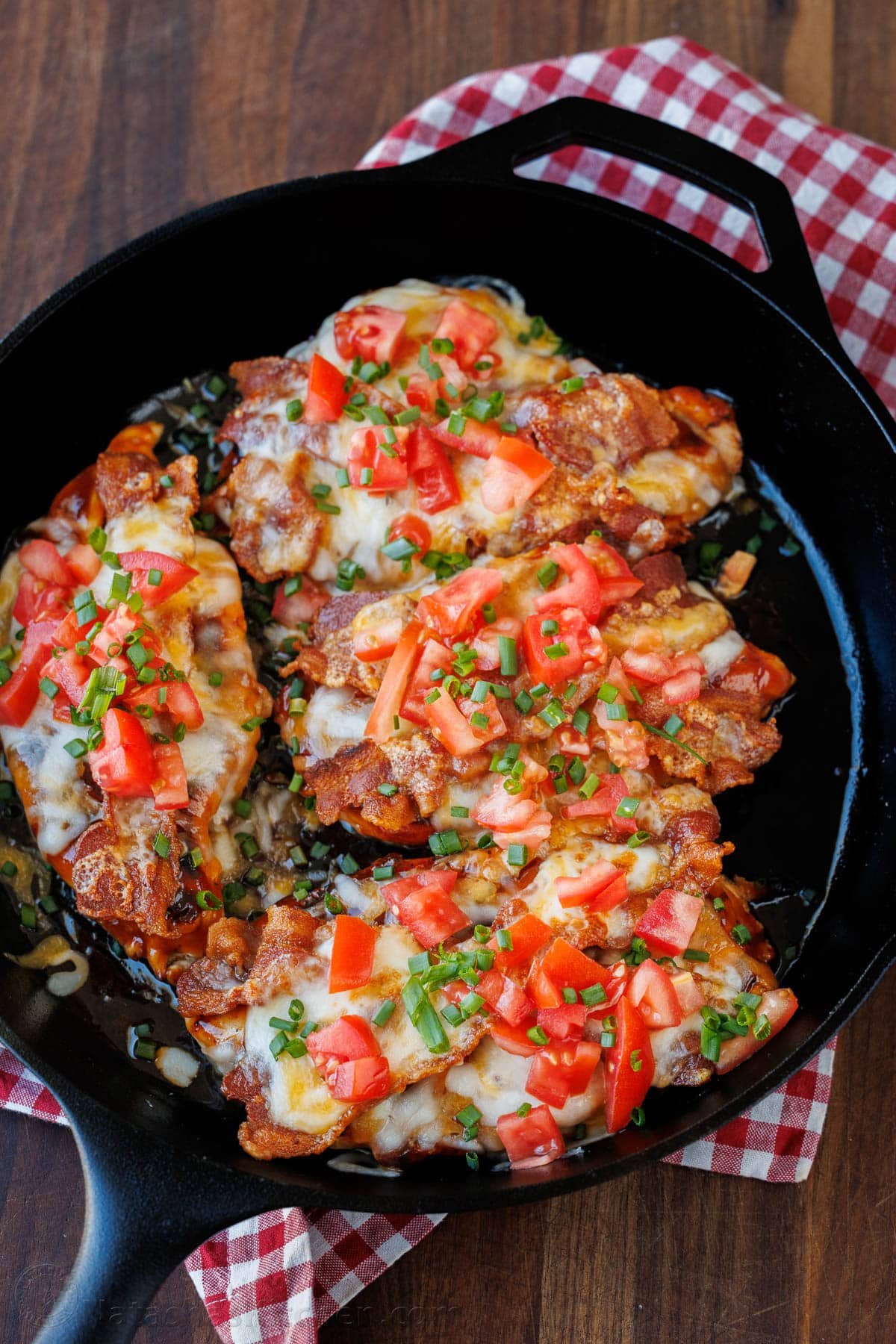 Our Chili's copycat Monterey Chicken recipe brings the grilled chicken, tangy BBQ, smoky bacon, and gooey cheese restaurant favorite home to your kitchen. Monterey Chicken topped with bacon, bbq sauce, cheese and tomatoes in a skillet