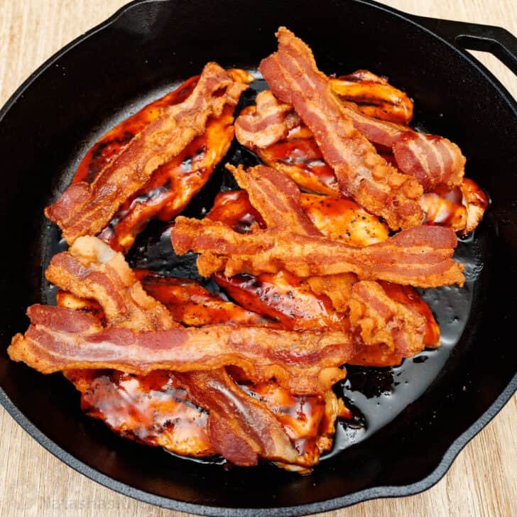 Our Chili's copycat Monterey Chicken recipe brings the grilled chicken, tangy BBQ, smoky bacon, and gooey cheese restaurant favorite home to your kitchen. Crispy bacon in a cast iron skillet