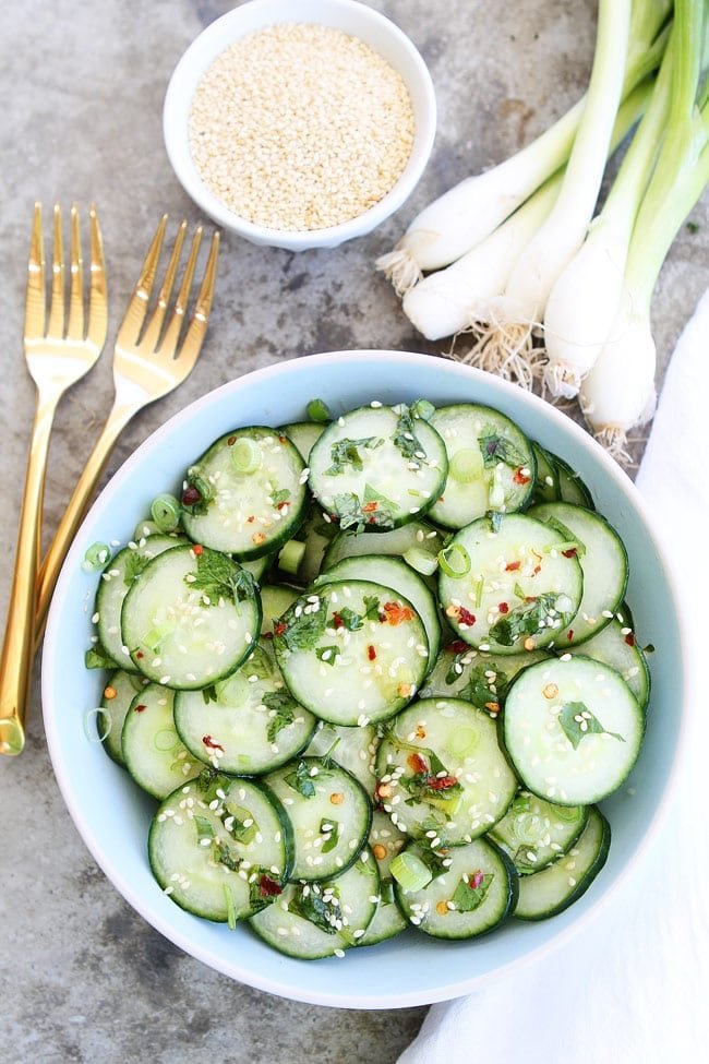 This easy and healthy Asian Cucumber Salad only takes minutes to make. It is a great side dish to any meal. Cucumber Salad ready to serve with red pepper flakes and sesame seeds
