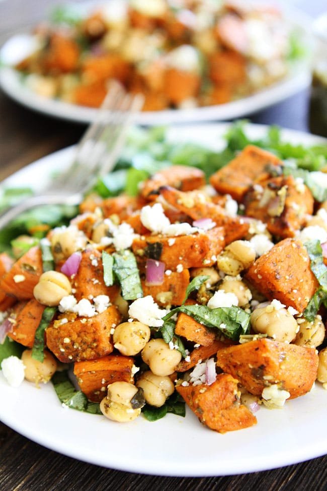Sweet Potato Chickpea Salad with Pesto Recipe on twopeasandtheirpod.com This simple salad is made with roasted sweet potatoes, chickpeas, red onion, basil, feta cheese, and pesto. It is great served as a main dish or side dish. Sweet Potato Chickpea Salad with Pesto Recipe