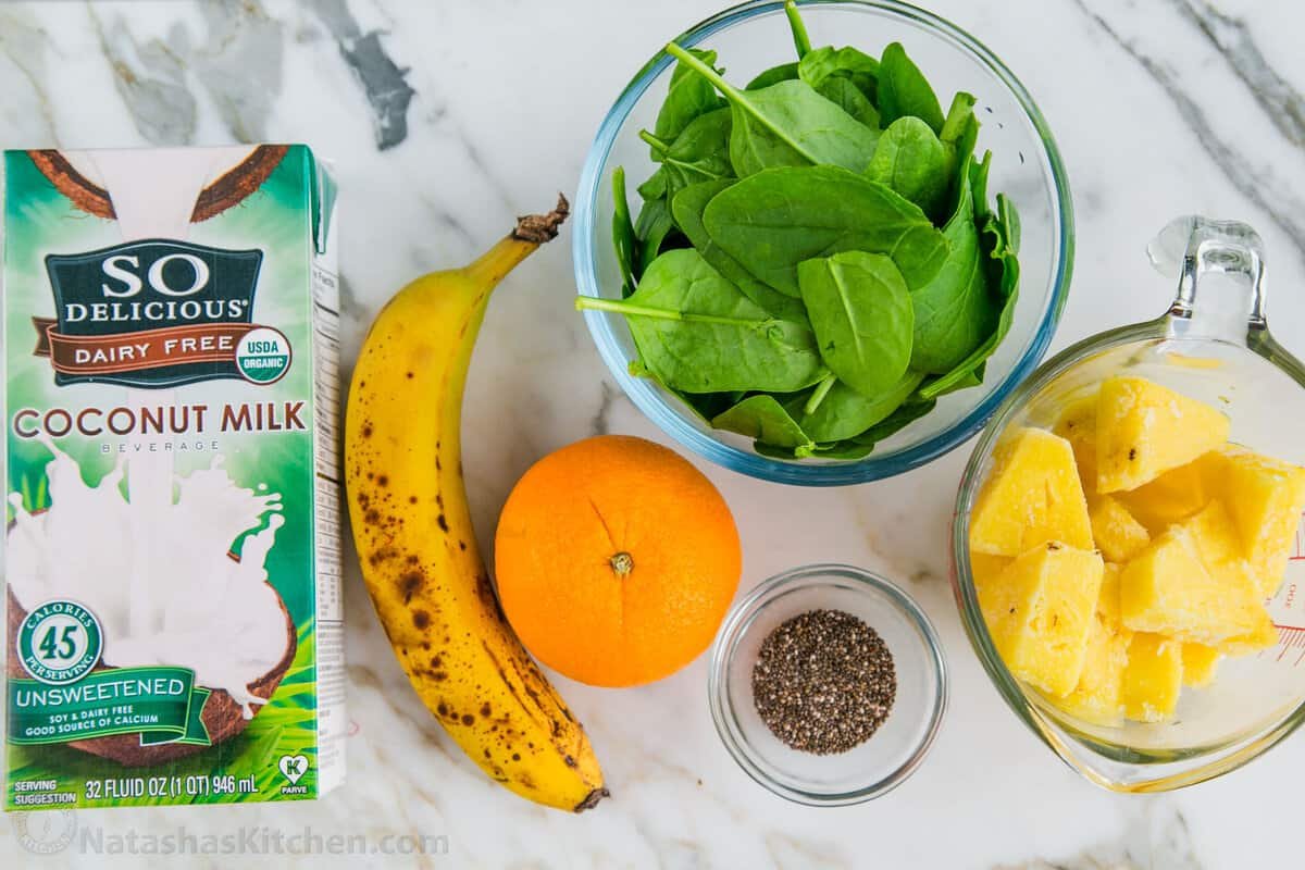 This Green Smoothie recipe is packed with nutritious ingredients like spinach, orange, pineapple, banana, and chia seeds. It's so refreshing. Ingredients for green smoothies, cocounut milk, banana, orange, spinach, frozen pineapple, and chia seeds