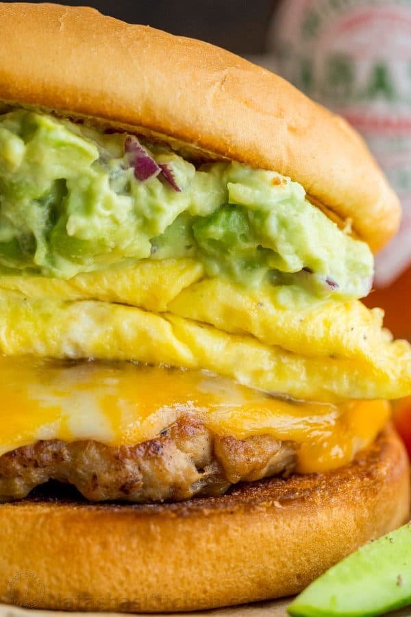 Spicy guacamole brunch sandwich with a crisp toasted bun, juicy sausage, melty cheese, fluffy eggs and guacamole! Easy guacamole breakfast sandwich! | natashaskitchen.com