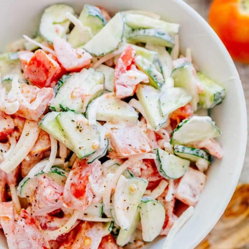 This CLASSIC creamy cucumber and tomato salad is so simple to make and is our go-to summer salad. An easy, excellent cucumber tomato salad. KEEPER! | natashaskitchen.com